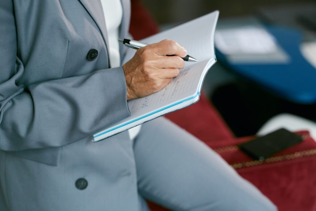 Businesswoman Writing in Note Book