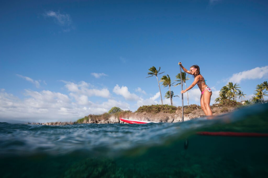 Woman paddleboarding on ocean