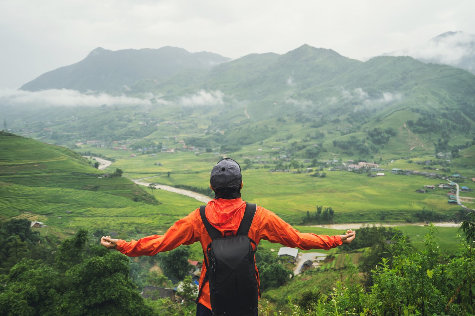 Young traveler standing and looking at view of nature